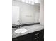 Bathroom with granite countertop vanity, sink, and large mirror at 7861 Hamilton Pool Dr, Las Vegas, NV 89113