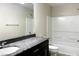 Bathroom with granite countertop vanity, sink, toilet, and shower-tub combo at 7861 Hamilton Pool Dr, Las Vegas, NV 89113