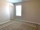 Bedroom featuring plush carpeting, base trim, and a neutral color palette at 7861 Hamilton Pool Dr, Las Vegas, NV 89113