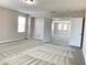 Expansive bedroom area with neutral patterned carpet, great natural light, and open access to the upper floor at 7861 Hamilton Pool Dr, Las Vegas, NV 89113