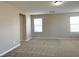 Bright bonus room with neutral carpet, large window, and plenty of space for activities at 7861 Hamilton Pool Dr, Las Vegas, NV 89113