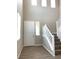Bright entryway with hardwood floors, high ceilings, and a staircase bathed in natural light at 7861 Hamilton Pool Dr, Las Vegas, NV 89113