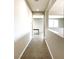 Hallway with wood-look flooring, neutral walls, and doorway leading to another room at 7861 Hamilton Pool Dr, Las Vegas, NV 89113