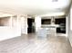 Open concept view of a modern kitchen featuring dark cabinetry, stainless appliances, and granite countertops at 7861 Hamilton Pool Dr, Las Vegas, NV 89113