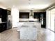 Modern kitchen with a granite island, stainless steel appliances, and dark wood cabinetry at 7861 Hamilton Pool Dr, Las Vegas, NV 89113