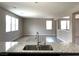 Spacious open layout with kitchen island overlooking the living area and backyard beyond at 7861 Hamilton Pool Dr, Las Vegas, NV 89113