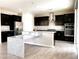 Spacious kitchen featuring dark wood cabinets, granite countertops, and stainless steel appliances at 7861 Hamilton Pool Dr, Las Vegas, NV 89113