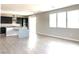 Open floorplan view from kitchen, highlighting wood floors and natural light from sliding glass doors at 7861 Hamilton Pool Dr, Las Vegas, NV 89113
