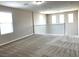 Spacious loft area with neutral carpet, multiple windows, and a white railing at 7861 Hamilton Pool Dr, Las Vegas, NV 89113