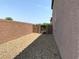 Side yard with gravel landscaping and privacy wall with gate at 7861 Hamilton Pool Dr, Las Vegas, NV 89113