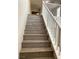 Staircase with wood-look steps and white railing leading upwards, featuring recessed lighting at 7861 Hamilton Pool Dr, Las Vegas, NV 89113