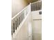 View of the staircase featuring white railing and wood-look steps in a well-lit space at 7861 Hamilton Pool Dr, Las Vegas, NV 89113