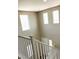 View from the top of the stairs, showcasing the white railing and entryway below at 7861 Hamilton Pool Dr, Las Vegas, NV 89113