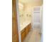 Bathroom featuring a single sink vanity and a view of the tub/shower combo through doorway at 8432 Apple Hill Ct, Las Vegas, NV 89128