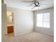 Bedroom showcases a ceiling fan, neutral carpet, and an ensuite bathroom for privacy at 8432 Apple Hill Ct, Las Vegas, NV 89128