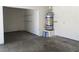 Garage interior showing a water heater and storage shelving at 8432 Apple Hill Ct, Las Vegas, NV 89128