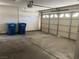 Garage with ample parking space and convenient trash bins, offering functionality and organization at 8432 Apple Hill Ct, Las Vegas, NV 89128