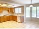 Well-lit kitchen features tile flooring, wood cabinetry, and a window over the sink at 8432 Apple Hill Ct, Las Vegas, NV 89128