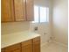 Functional laundry room with cabinetry, countertop space, and a window at 8432 Apple Hill Ct, Las Vegas, NV 89128
