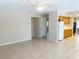 Spacious living area with tile floors, white refrigerator and ample natural light at 8432 Apple Hill Ct, Las Vegas, NV 89128