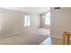Bright and airy living room features neutral walls and plush carpeting at 8432 Apple Hill Ct, Las Vegas, NV 89128