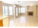 Inviting living area with a cozy fireplace, tile flooring, and access to the backyard at 8432 Apple Hill Ct, Las Vegas, NV 89128