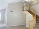 Spacious living room with a staircase, neutral walls, and tile flooring at 8432 Apple Hill Ct, Las Vegas, NV 89128