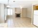 Open-concept living room features tile flooring, a fireplace, and backyard access at 8432 Apple Hill Ct, Las Vegas, NV 89128
