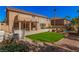Expansive backyard featuring artificial turf, mature trees, pool, and covered patio at 8809 Barium Rock Ave, Las Vegas, NV 89143