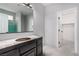 Bathroom under construction with a framed mirror and vanity with an unfinished countertop at 8809 Barium Rock Ave, Las Vegas, NV 89143
