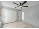This bedroom features a ceiling fan, double door closet and bright light at 8809 Barium Rock Ave, Las Vegas, NV 89143