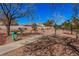 Shaded community walking path with trees, grass, and clear blue sky at 8809 Barium Rock Ave, Las Vegas, NV 89143