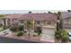 Two-story stucco home featuring a balcony and well-maintained landscaping at 8809 Barium Rock Ave, Las Vegas, NV 89143