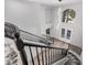 Spacious foyer boasts a staircase with black railing and a contemporary chandelier at 8809 Barium Rock Ave, Las Vegas, NV 89143
