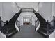 Grand foyer with a dual staircase and a view into the open living area at 8809 Barium Rock Ave, Las Vegas, NV 89143