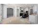 Kitchen area featuring black and white cabinets, and an unfinished floor at 8809 Barium Rock Ave, Las Vegas, NV 89143