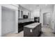 Kitchen area featuring white cabinets and a black island, under construction at 8809 Barium Rock Ave, Las Vegas, NV 89143