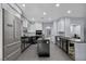 Modern kitchen boasts black cabinetry, stainless steel appliances, and a central island, perfect for cooking at 8809 Barium Rock Ave, Las Vegas, NV 89143