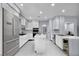Modern kitchen boasts white cabinetry, stainless steel appliances, and a central island, perfect for cooking at 8809 Barium Rock Ave, Las Vegas, NV 89143