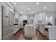 Modern kitchen boasts white cabinetry, stainless steel appliances, and a central island, perfect for cooking at 8809 Barium Rock Ave, Las Vegas, NV 89143
