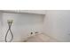 A blank laundry room area has the electrical and water hookups installed on the wall at 8809 Barium Rock Ave, Las Vegas, NV 89143