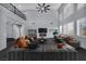 Bright living room featuring high ceilings, large windows with shutters, and contemporary furnishings at 8809 Barium Rock Ave, Las Vegas, NV 89143