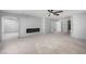 Large living area boasting a modern electric fireplace, ceiling fan, and seamless transition to other spaces at 8809 Barium Rock Ave, Las Vegas, NV 89143