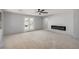 Bright living room with an electric fireplace and access to the balcony at 8809 Barium Rock Ave, Las Vegas, NV 89143