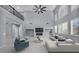 Bright, two-story living room with floor-to-ceiling windows and modern fireplace at 8809 Barium Rock Ave, Las Vegas, NV 89143