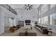 Bright, two-story living room with floor-to-ceiling windows and modern fireplace at 8809 Barium Rock Ave, Las Vegas, NV 89143
