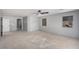 Bright living room featuring access to other rooms, a ceiling fan, and windows at 8809 Barium Rock Ave, Las Vegas, NV 89143