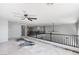 Open loft area with dark railing, high ceilings, and ceiling fans, perfect for a flexible living space at 8809 Barium Rock Ave, Las Vegas, NV 89143