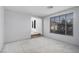 Bright room featuring a large window and access to another room at 8809 Barium Rock Ave, Las Vegas, NV 89143