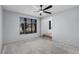 Bright room featuring a large window and access to another room at 8809 Barium Rock Ave, Las Vegas, NV 89143